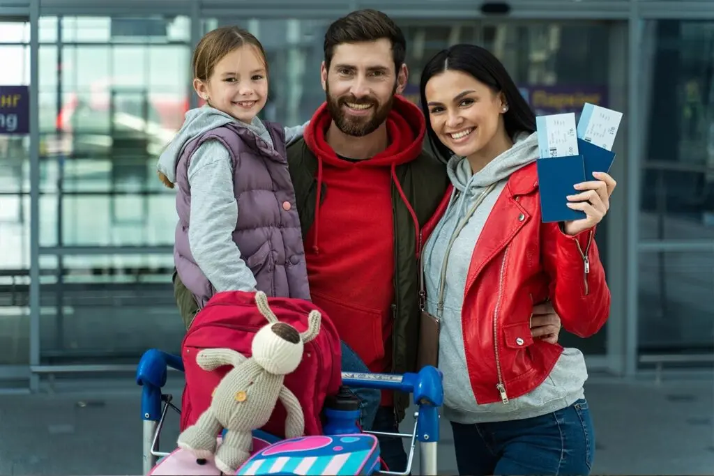 A family at an airport with tickets and visas going to travel