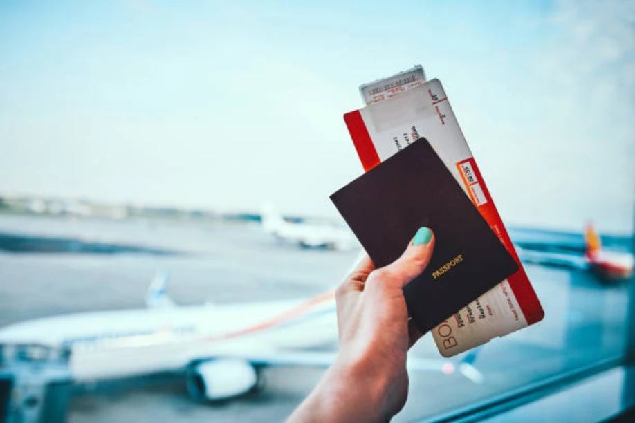 someone holding a passport and visa in an airport