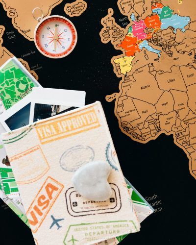 Explore the world with this colorful travel map, compass, and passport stamps.